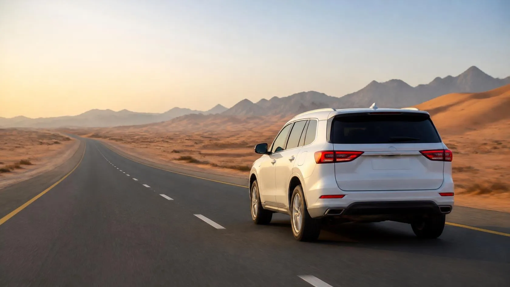 White SUV on a desert highway in the UAE
