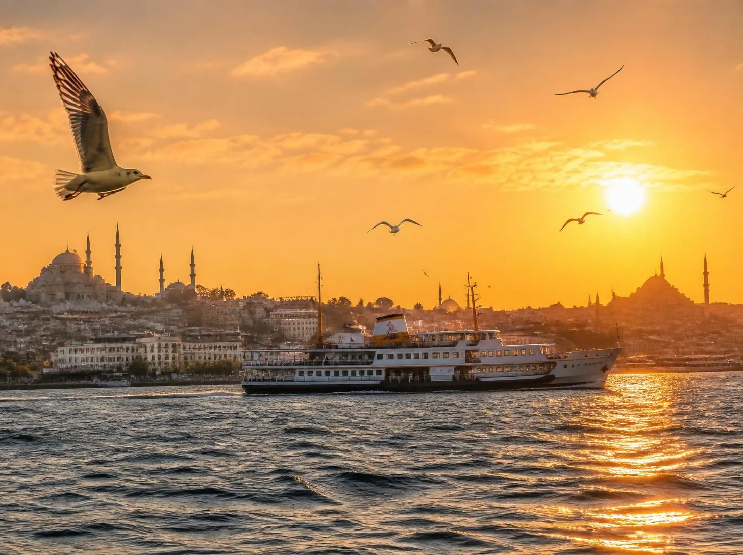 Istanbul skyline and a Bosphorus ferry at sunset