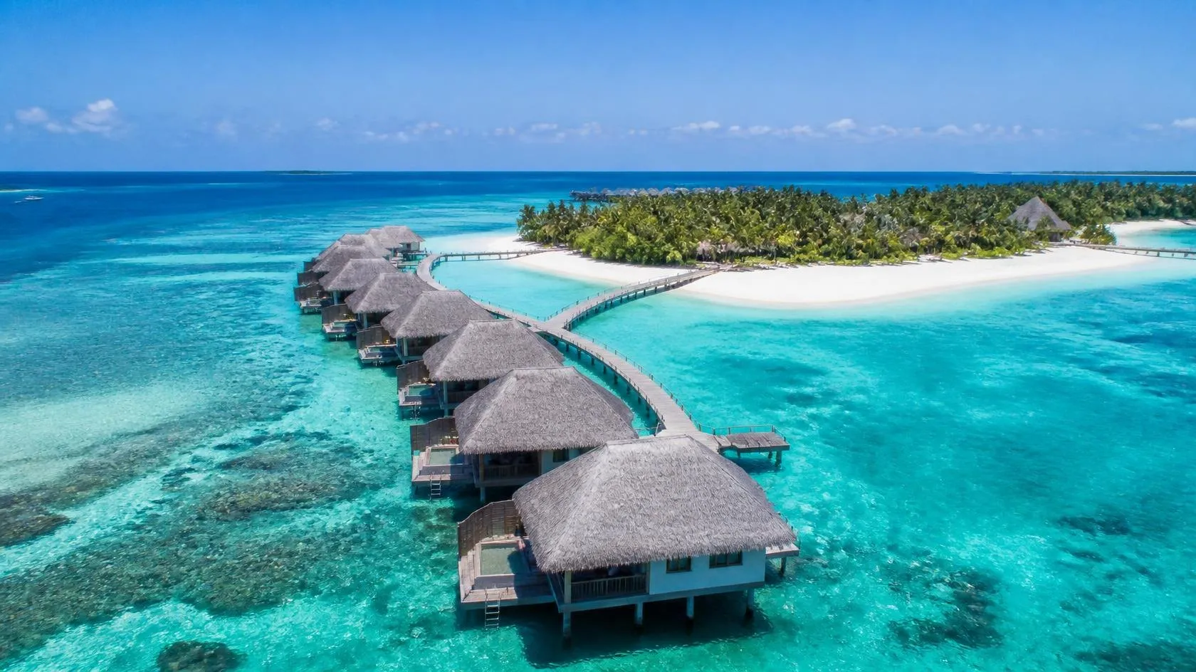Overwater villas on a turquoise lagoon in the Maldives